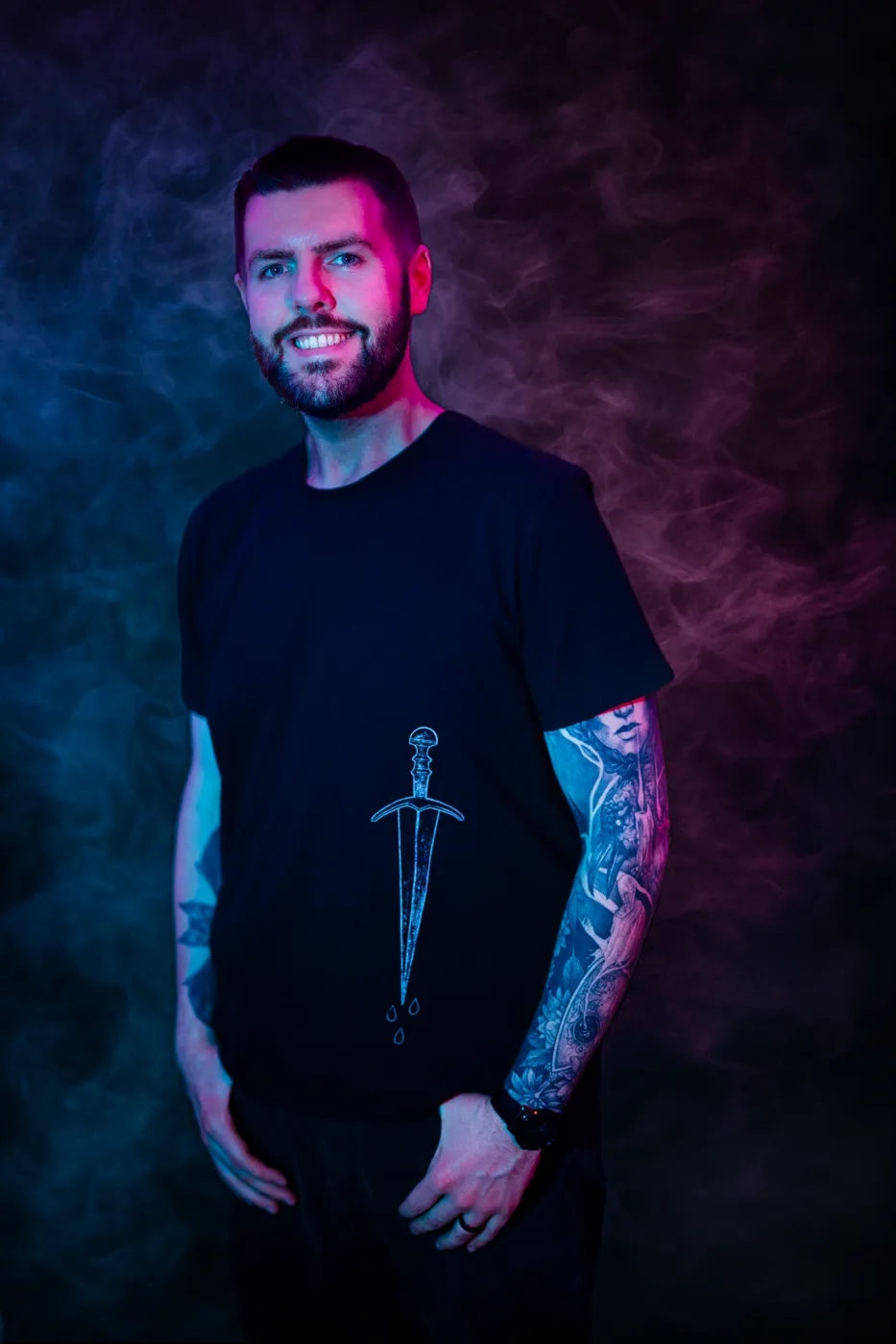 Ben Rekemeyer standing against blue and violet haze.