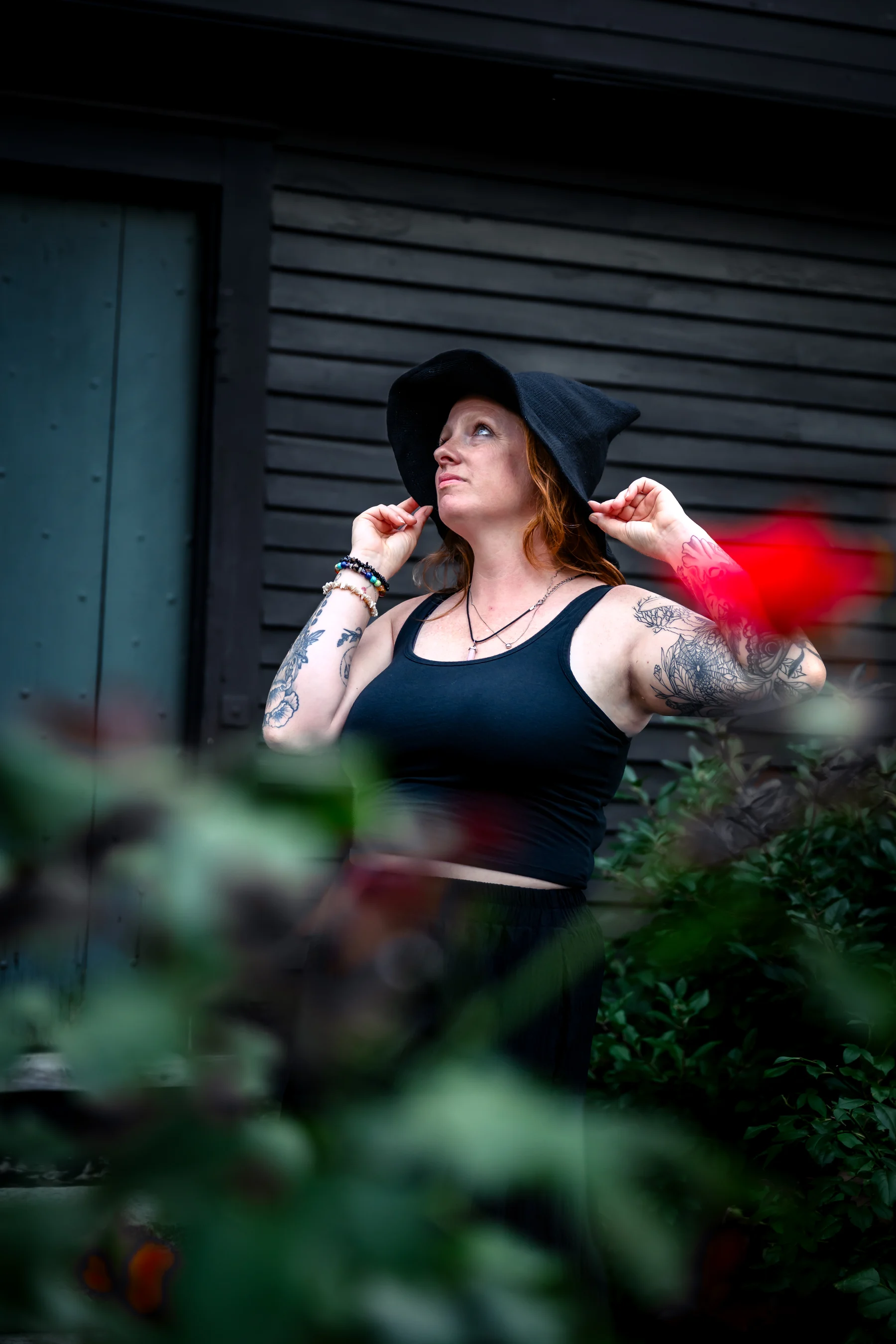 A witch-hat portrait beside the Witch House
